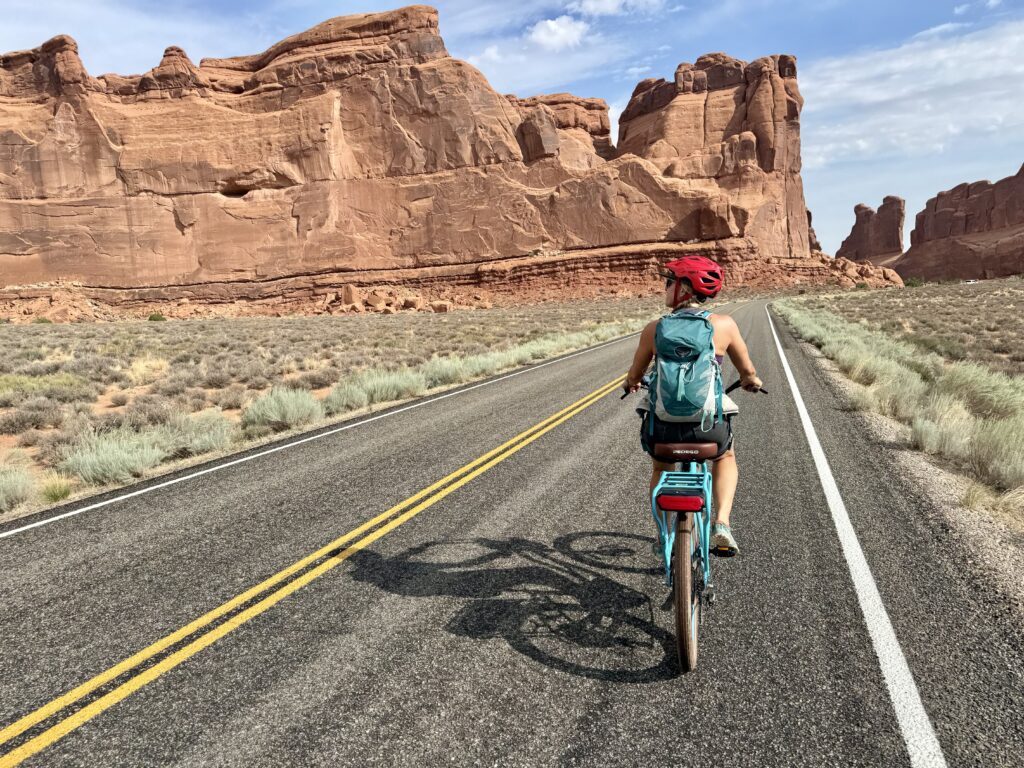 Woman biking through Arches National Park on e-bike
