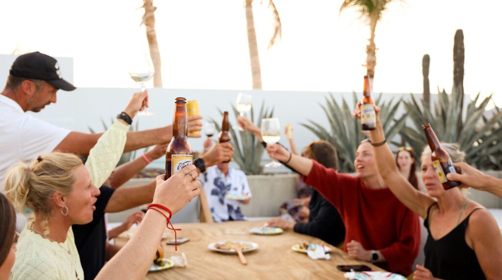 Kite camp group cheers during a dinner