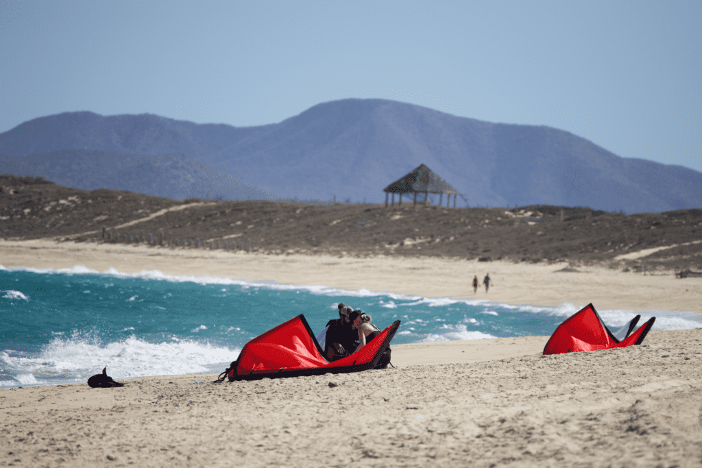 instructor with a woman teaching kiteboarding basics on the beach in La Ventana