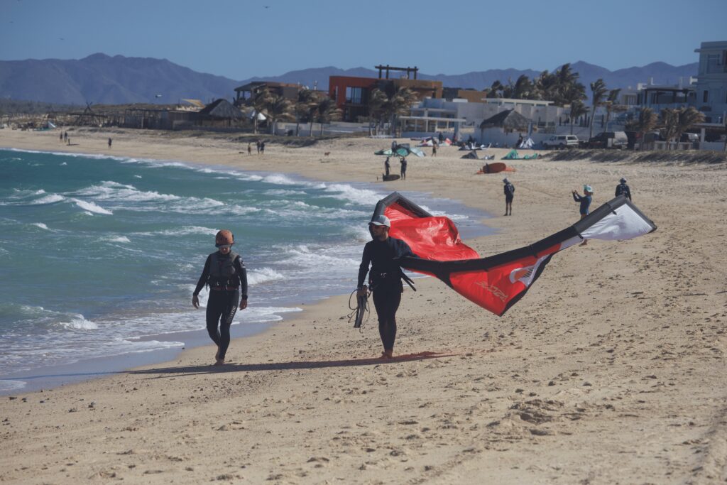 instructor walking with the student down the beach during a kite lesson