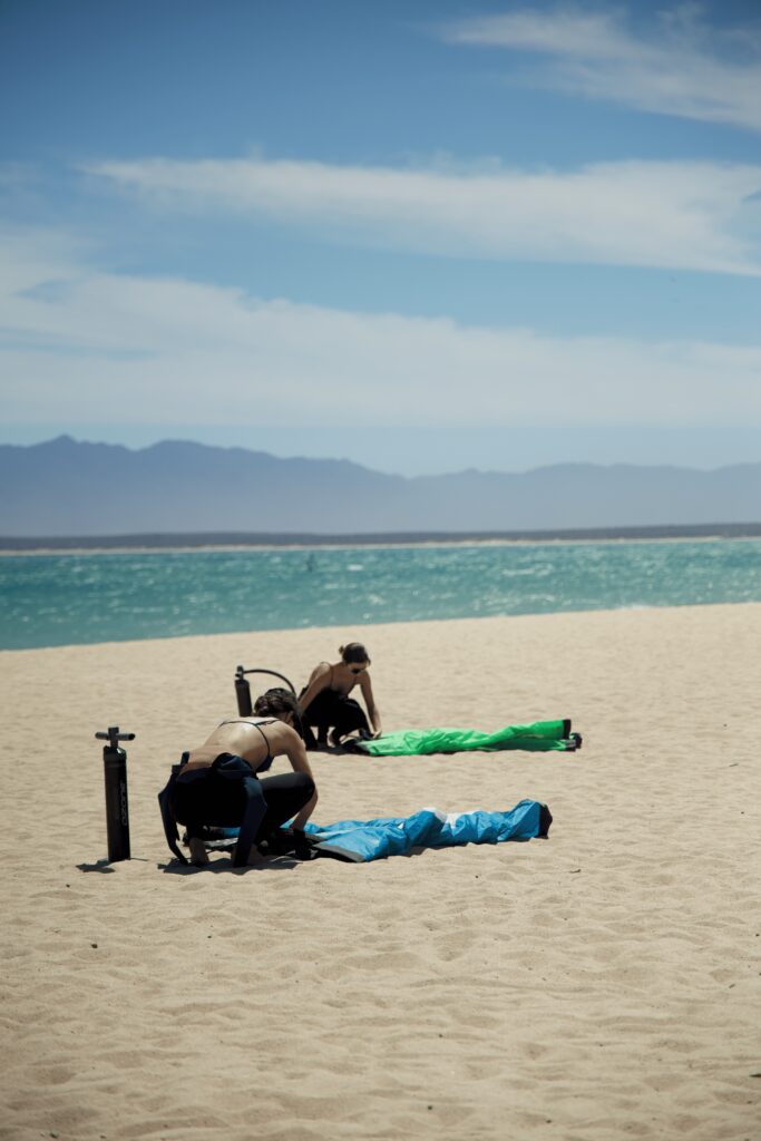 students folding up kite gear after a kite lesson