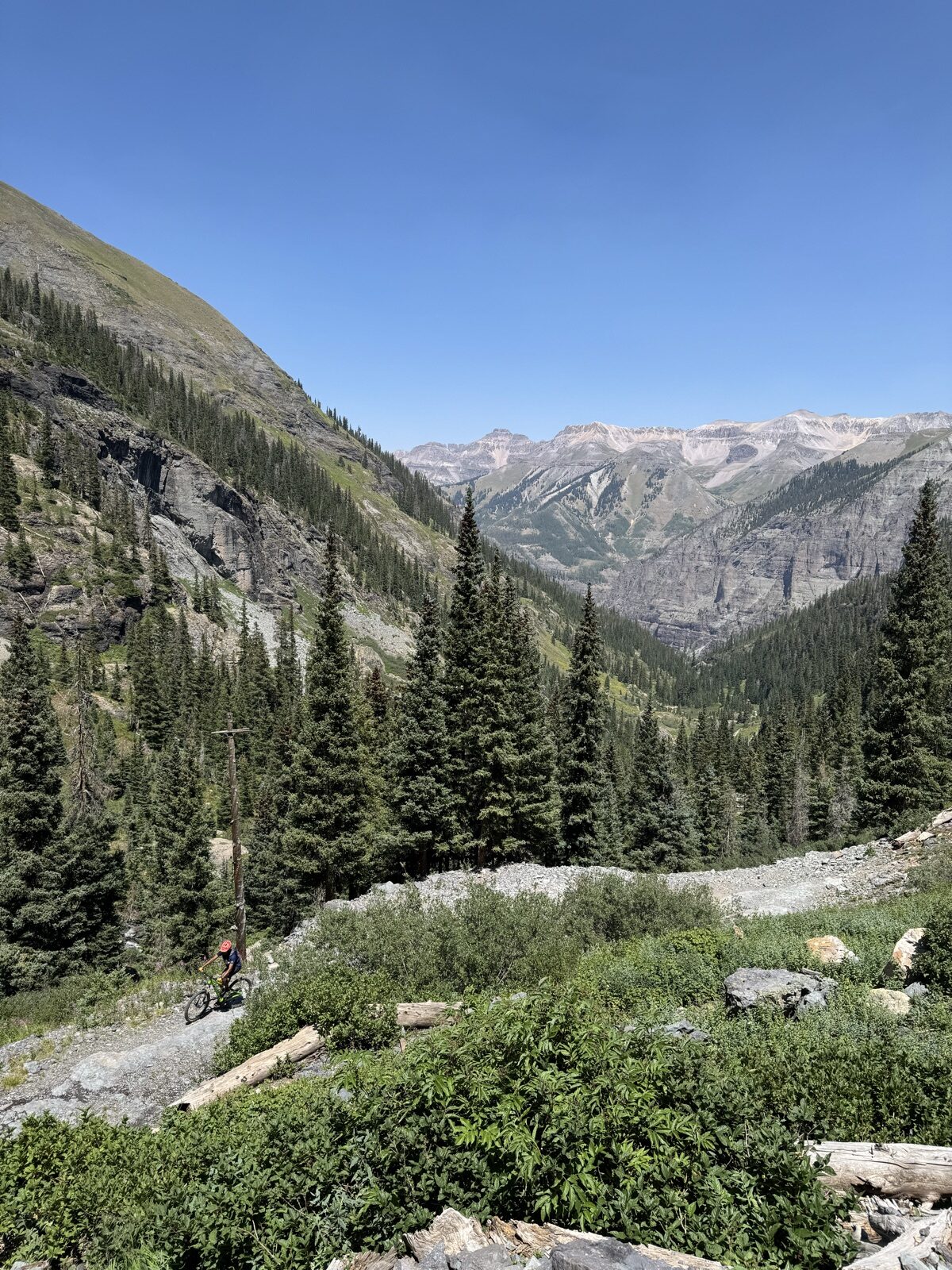 Mountain biker climbing old mining doubletrack in Bridal Veil Basin