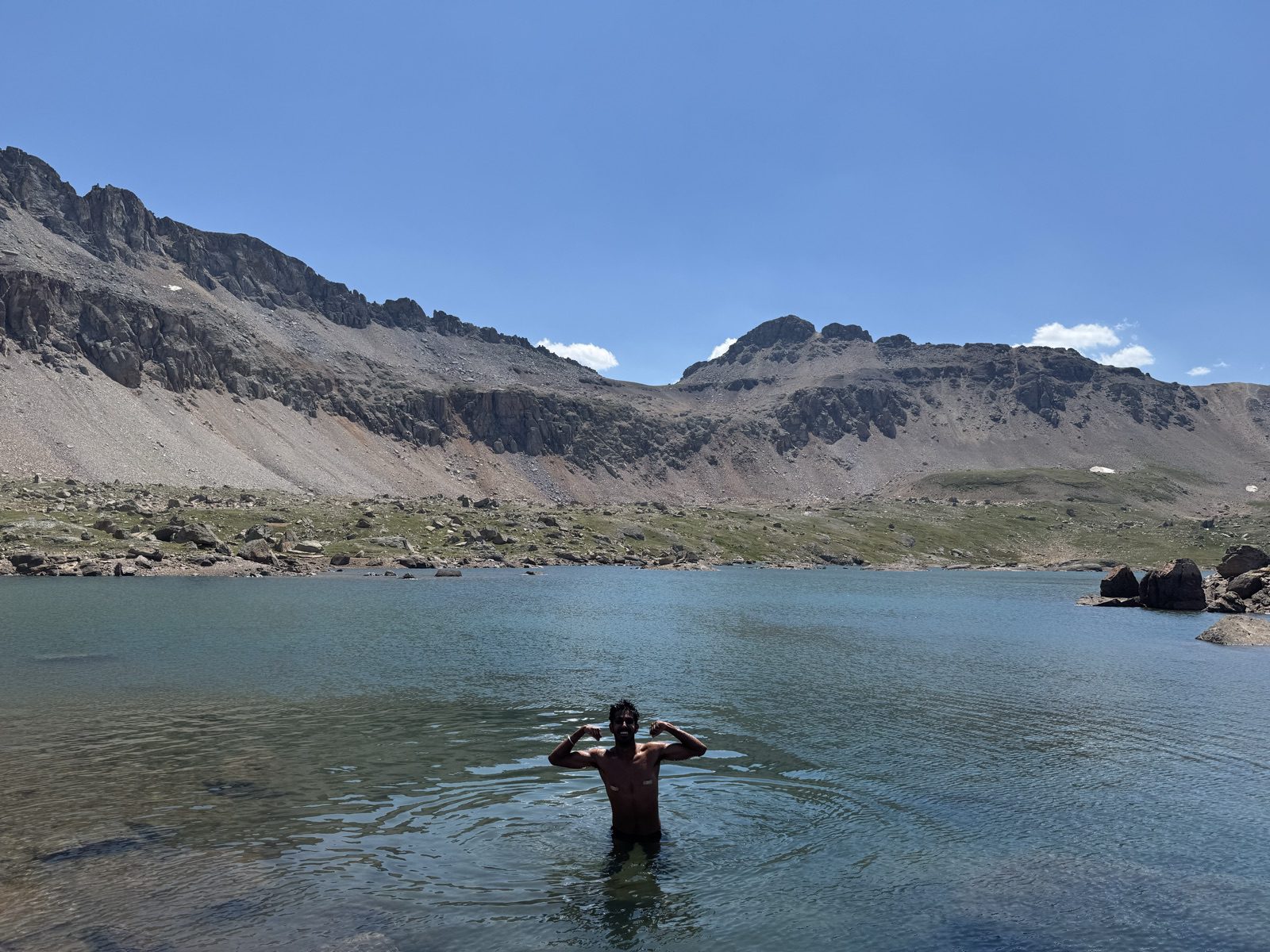 Swimmer flexing in the turquoise water of Lewis Lake at 12,700 feet