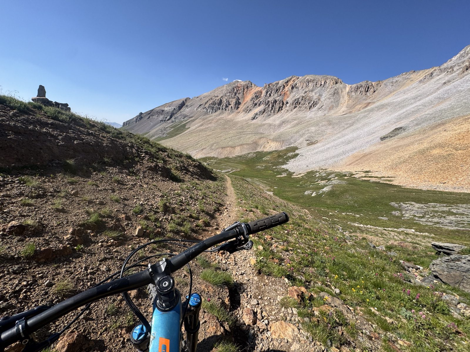 View over handlebars descending alpine singletrack into the Wasatch basin